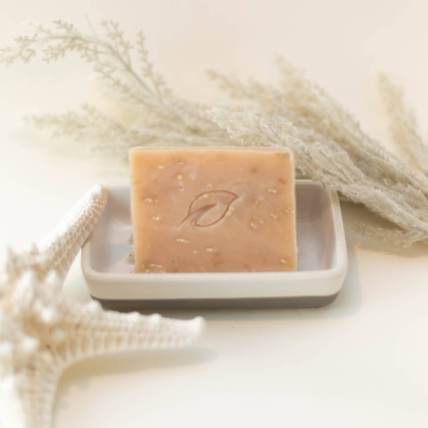 Light Green Soap Bar on White Soap dish surrounded by cucumners and green tea